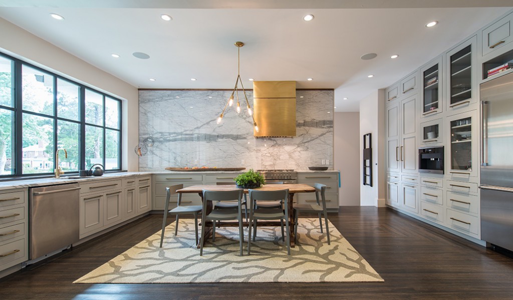 The centerpiece of the kitchen is a ceiling-high backsplash that was added to use up marble slabs. Photo by Nathan Harmon.