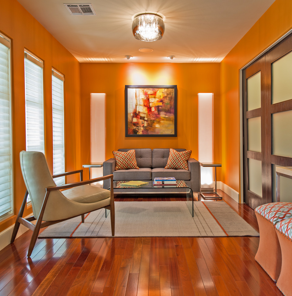 The sitting area in the study features a custom loveseat and leather-covered accent chair.
