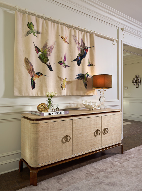 A hummingbird tapestry from the Alexander McQueen collection for The Rug Company hides a recessed flat screen television. Photo by David Cobb