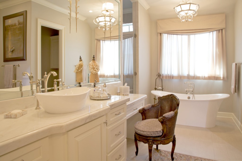 Limestone flooring and the freestanding tub keep the space feeling light and airy.