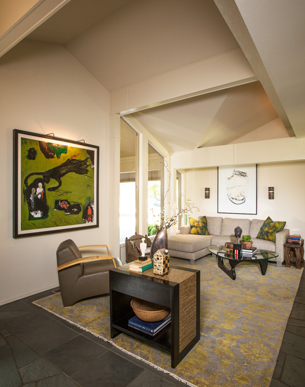 The home’s dramatic entryway provides glimpses into the downstairs common areas, including the living room and kitchen.