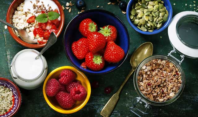 Healthy breakfast of muesli, berries with yogurt and seeds