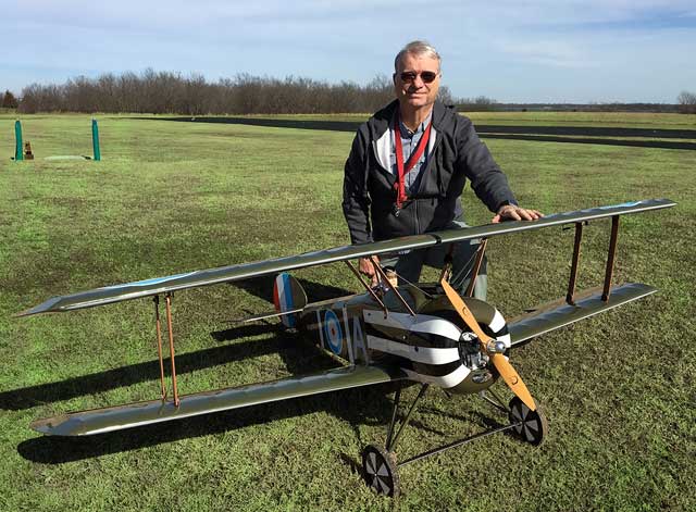 Doug Bromley of the Tulsa Glue Dobbers with his plane, the Sopwith Camel.
