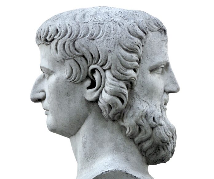 Janus sculpture on a black background. Marble bust of the mythol