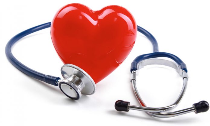 Red heart and a stethoscope on desk
