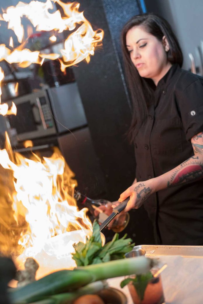 Rachel Suitt cooks wth fresh ingredients at NOIR in OKC.Photo by Brent Fuchs