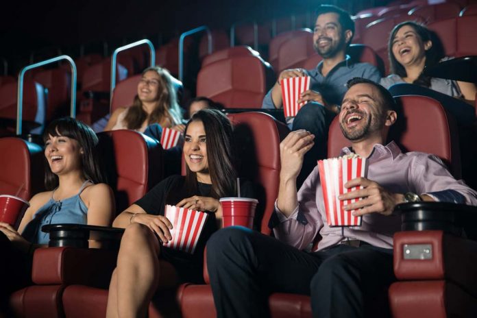 Group of people laughing at the movie theater