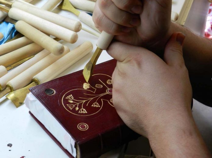 Bookbinder Sean Richards restores delicate tomes.