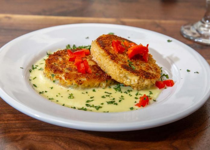Nola's skiffer crab cakes are pan-seared with white wine sauce.