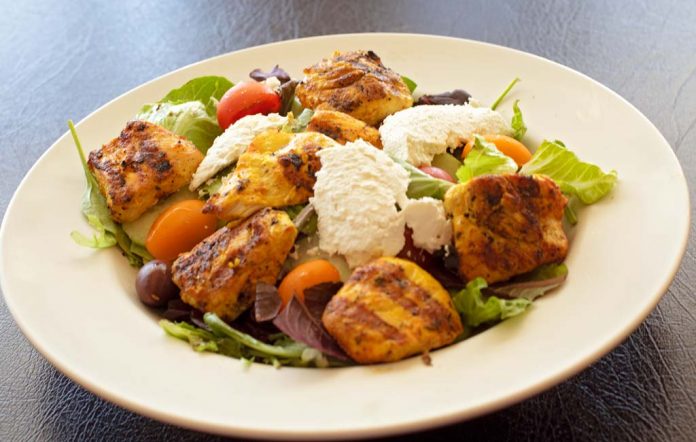 Grilled chicken salad is a simple, delicious menu item at Travel by Taste.