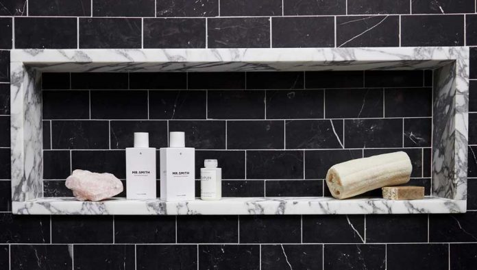 A shower in the home features dramatically contrasting materials.