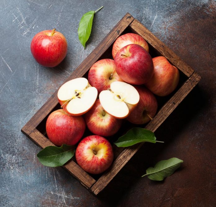 Red apples in wooden box