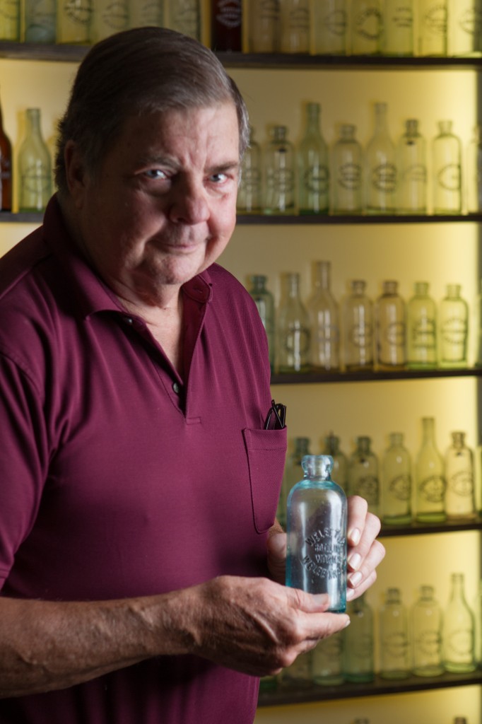 Johnnie Fletcher is an expert on old oklahoma bottles. Right: Fletcher proudly displays his collection on shelves in his garage.