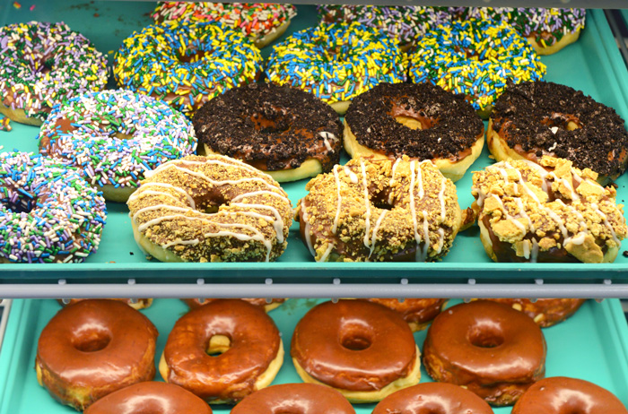 The display case at Livi Lee’s newest Sand Springs location shows off colorful and sweet doughnuts. Photo by Natalie Green.